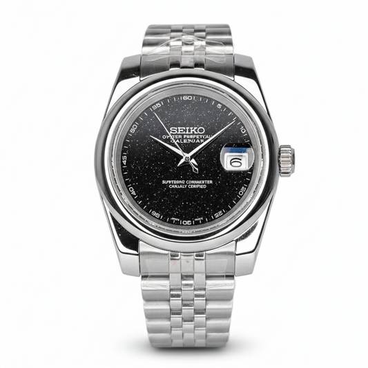 Seiko watch with black dial and silver metal strap on a white background